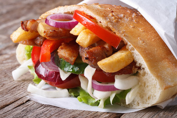 kebab with meat, vegetables and fries in pita bread