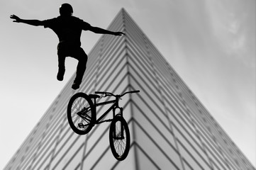 Silhouette bmx sport rider in action with scenery background