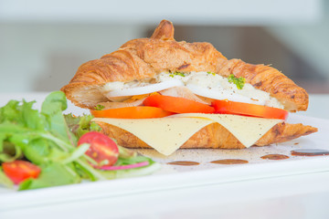 Croissant with cheese tomato chicken and salad
