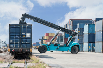 Fototapeta premium forklift handling container box loading to freight train