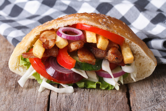 delicious doner kebab with meat, vegetables and fries in pita
