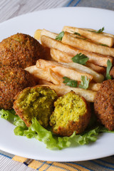 falafel with French fries, salad on the white plate vertical