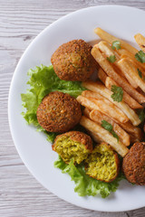 falafel with French fries, lettuce top view vertical