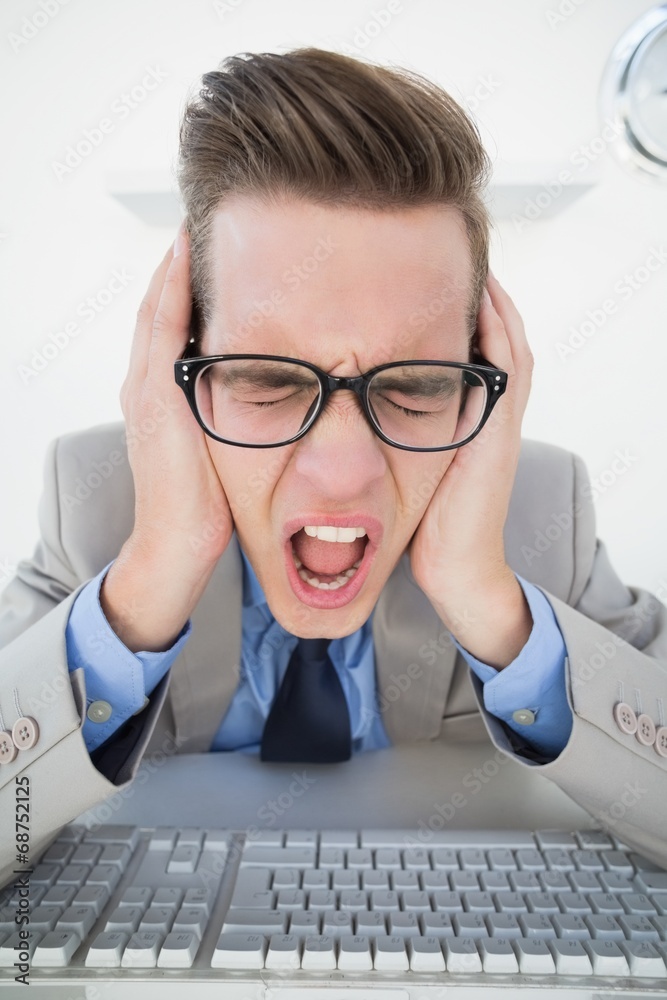 Poster angry businessman working on computer