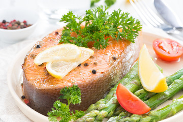 baked salmon with asparagus, parsley and lemon, close-up