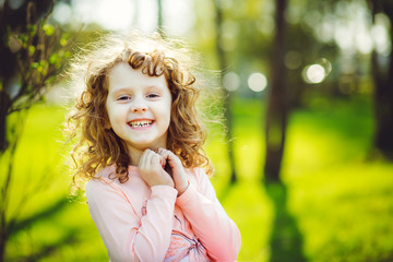 Little sunny girl is smiling.