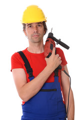 worker with helmet and drilling machine