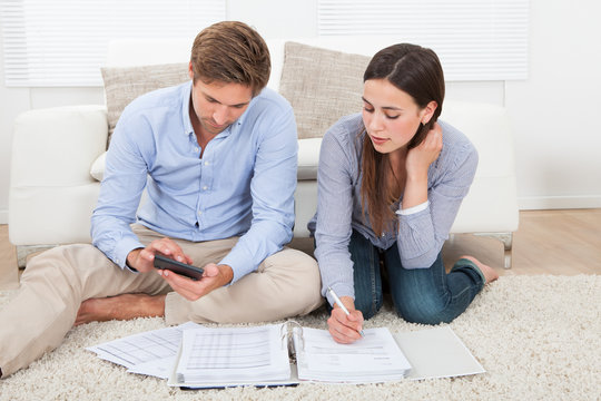 Couple Calculating Budget At Home