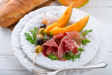 Ham with melon and olives