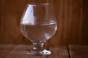 glass of water on a wooden background