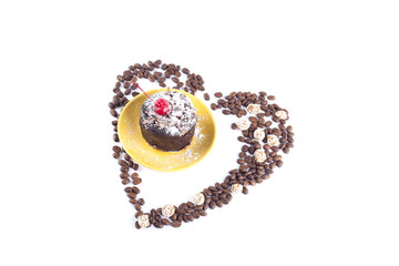 Delicious chocolate cake surrounded by heart shaped coffee beans