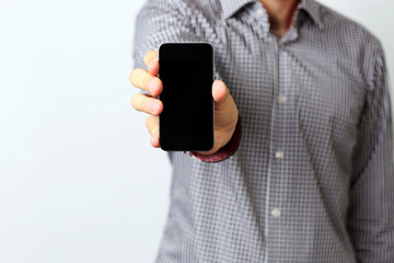 Closeup image of a male hands holding smartphone