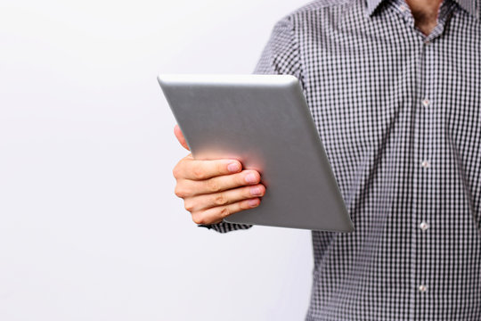 Closeup image of a man holding tablet computer