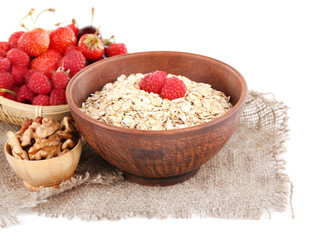 Wooden bowls of berries on sackcloth isolated on white