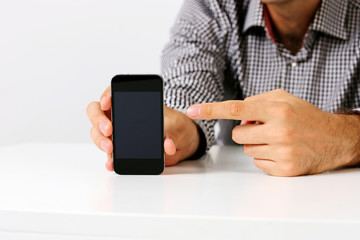 Closeup image of a man pointing on the smartphone screen