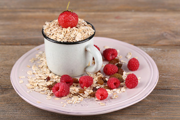 Big plate of oatmeal and berries on wooden background