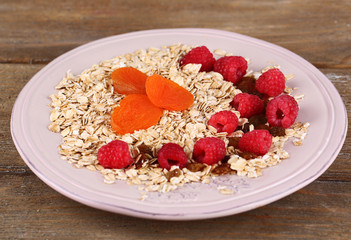 Big plate of oatmeal and berries on wooden background