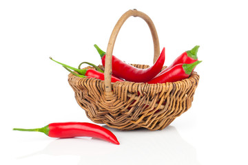 Fototapeta na wymiar Red chili pepper in a wicker basket, isolated on white backgroun