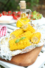 Grilled corn cobs on table, close-up
