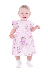 Small smiling baby girl in pink dress over white background