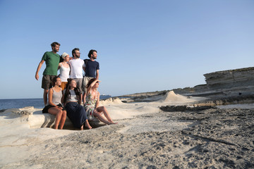 group posing for a photo at the seaside