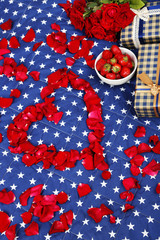 Romantic still life with strawberry, gift boxes and petals of