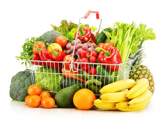 Wire shopping basket with groceries isolated on white