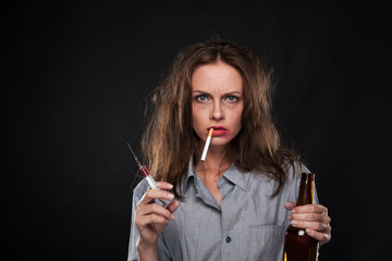 Obraz premium portrait of woman smoking cigarette hanging out of her mouth.