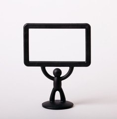 plastic figurine of a man with a placard on white background