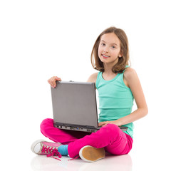 Smiling little girl with a laptop