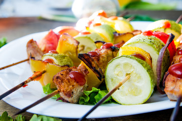 skewers of meat and fresh vegetables