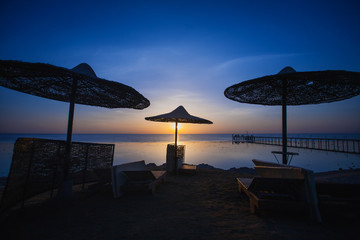 Sunset on the beach with parasol