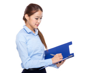 Businesswoman write on clipboard
