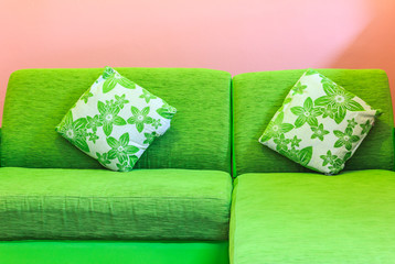 Green sofa in pink room