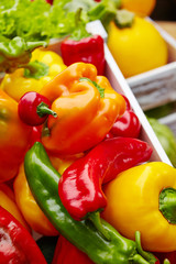 Colorful peppers in a wooden box