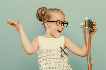  smiling child  holding a  camera