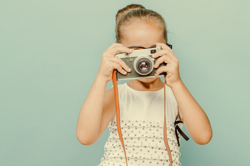  smiling child  holding a  camera