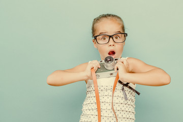  smiling child  holding a  camera