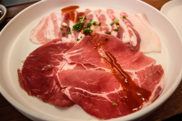 Raw pork on white plate