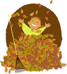 Little boy playing in a pile of fallen leaves