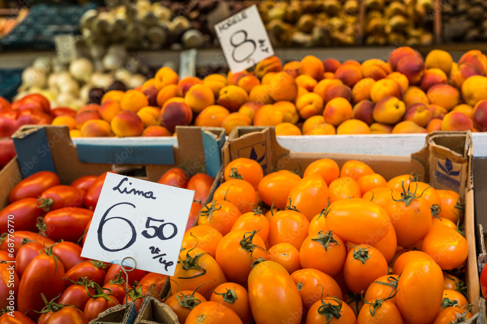 Wall mural fresh tomatoes in a market stall in poland.