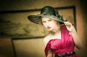 Charming blonde woman with black hat, retro image © iancucristi