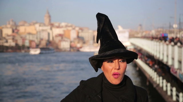 Woman with witch hat outside istanbul city