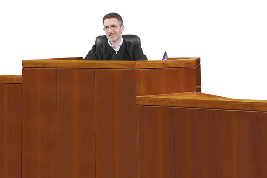 middle aged caucasian american judge in a robe sitting
