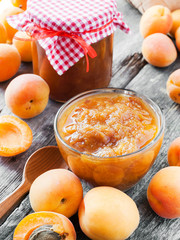 apricot fruits and jar of jam on table
