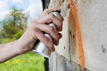 Hand holding graffiti spray