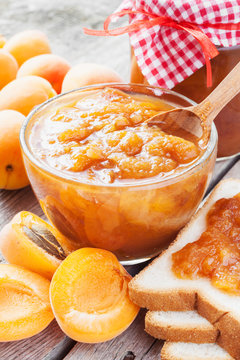 apricot fruits and jar of jam on table