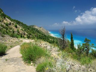 Fototapeta na wymiar Beautiful turquoise sea and coastal hills with trees