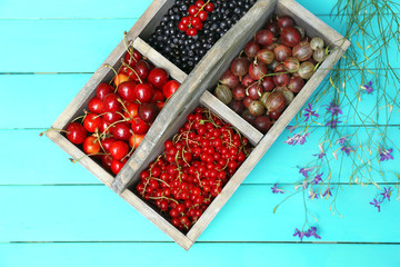Fresh berries in wooden box, close up