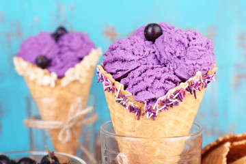 Tasty ice cream with berries in waffle cones